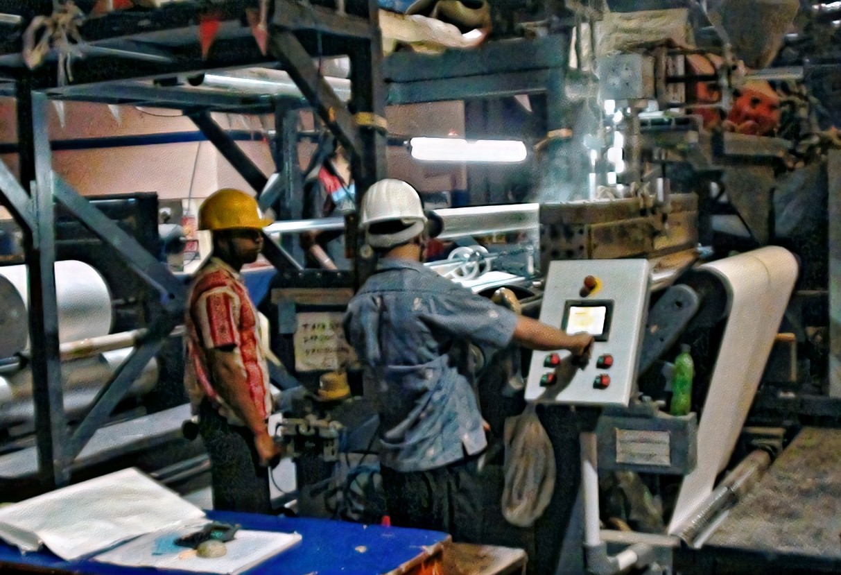 Operators at a lamination machine